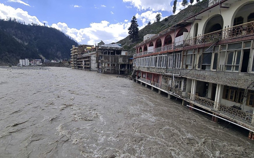 Damaged hotels are surrounded by floodwaters in Kalam, Pakistan, Monday, Aug. 29, 2022. Disaster officials say nearly a half million people in Pakistan are crowded into camps after losing their homes ...