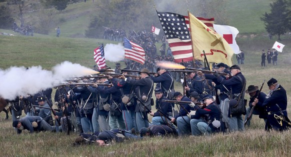 FILE - Union troops fire upon advancing Confederate troops during a reenactment of the Civil War Battle of Cedar Creek on Oct. 18, 2015, at the Cedar Creek battlefield just south of Middletown, Va. A  ...