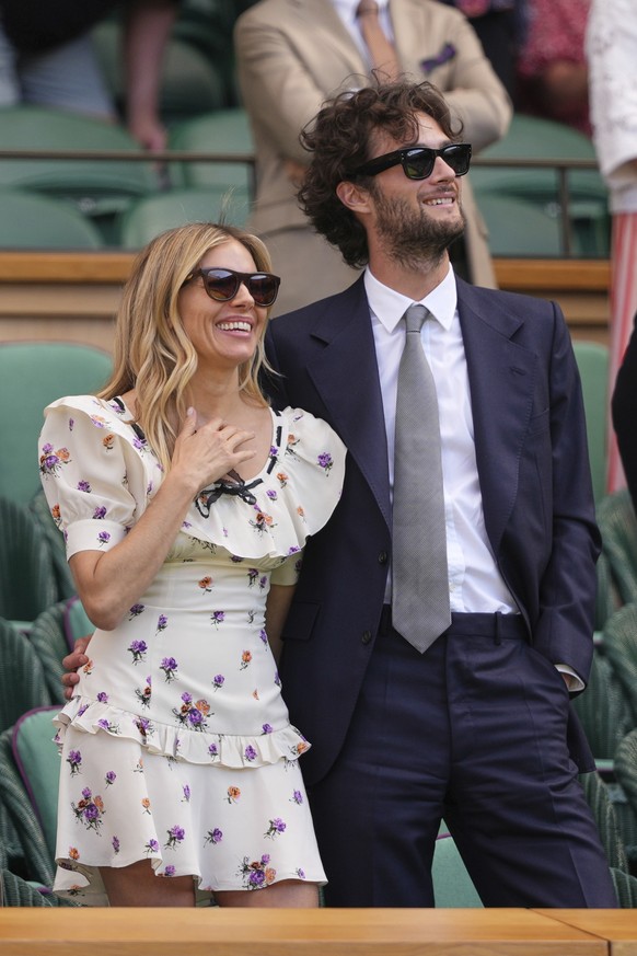 Actor Sienna Miller and her partner Oli Green stand in the Royal Box on Centre Court on day nine at the Wimbledon Tennis Championships in London, Tuesday, July 8, 2025. (AP Photo/Kirsty Wigglesworth)
 ...