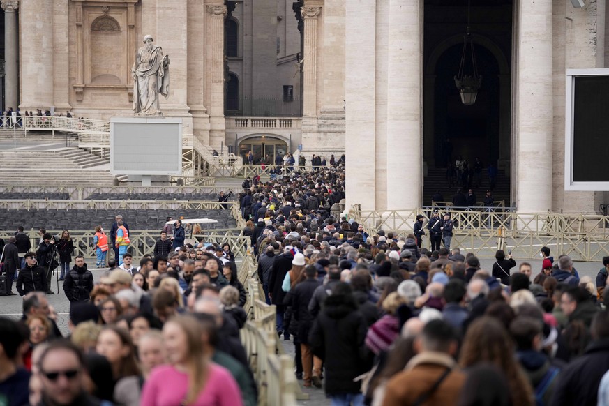 People wait in a line to enter Saint Peter's Basilica at the Vatican where late Pope Benedict 16 is being laid in state at The Vatican, Monday, Jan. 2, 2023. Benedict XVI, the German theologian w ...