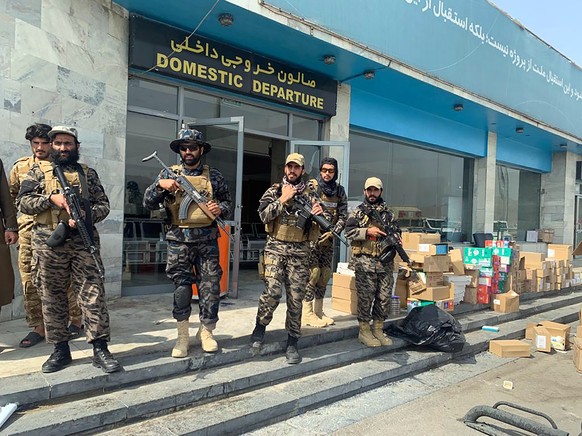 Taliban fighters stand guard inside the Hamid Karzai International Airport after the U.S. withdrawal in Kabul, Afghanistan, Tuesday, Aug. 31, 2021. The Taliban were in full control of Kabul&#039;s int ...