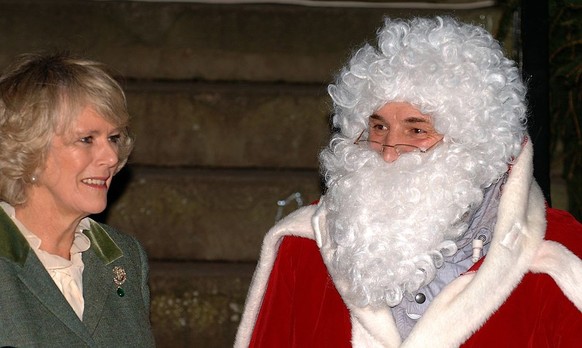 TETBURY- NOVEMBER 30: Camilla, Duchess of Cornwall stands with Father Christmas as she turns on the Christmas lights on November 30, 2006 in Tetbury, England. (Photo by Anwar Hussein/Getty Images)