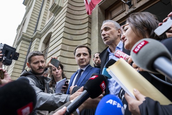 epa10649971 Swiss leading Islamic scholar Tariq Ramadan (C) walks out and speaks to the press after he was acquitted on charges of sexual assault, in Geneva, Switzerland, 24 May 2023. A Geneva court a ...