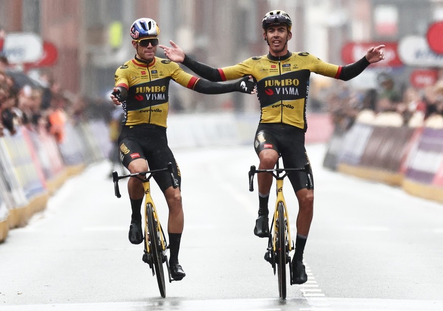 epa10544272 France&#039;s Christophe Laporte (R) of the Jumbo Visma team wins ahead of Belgian teammate Wout Van Aert (L) the Gent-Wevelgem one day cycling race, in Wevelgem, Belgium, 26 March 2023. E ...