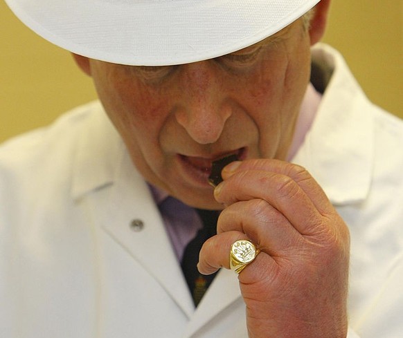 DORCHESTER- DECEMBER 12: (NO PUBLICATION IN UK MEDIA FOR 28 DAYS) Prince Charles, Prince of Wales tastes a Duchy Original chocolate on the production line during his tour of the Dorchester Chocolate F ...