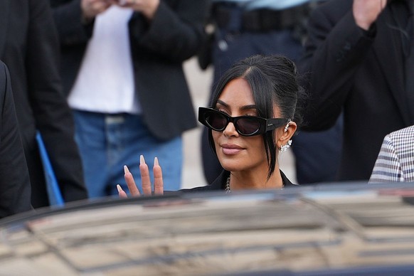 PARIS, FRANCE - MAY 13: Kim Kardashian exits the trial at the Palais de Justice, and wears sunglasses by Alaia, Repossi diamond earcuffs, Brioni Raymond earrings, at the Palais de Justice, on May 13,  ...