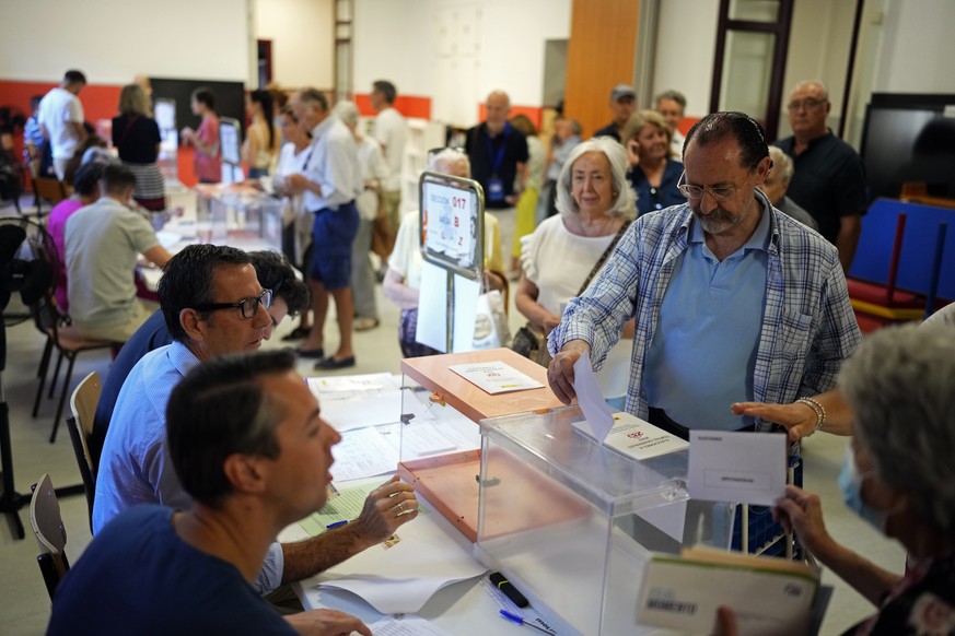 A man casts his ballot at a polling station to vote in general elections in Madrid, Spain, Sunday July 23, 2023. Voters in Spain go to the polls Sunday in an election that could make the country the l ...
