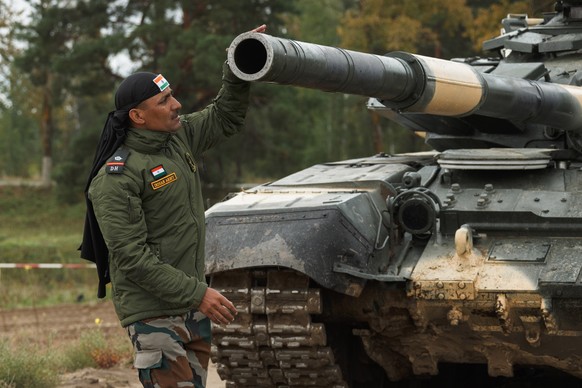 epa09465792 A handout photo made available by .... A handout picture made available by Russian Defence ministry press service shows Indian serviceman prepares his T-72 main battle tank during the Zapa ...