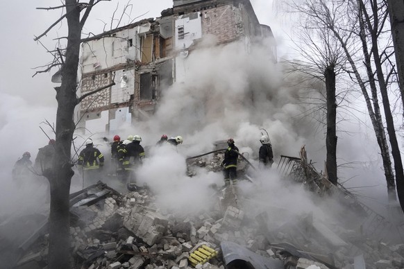 Rescuers work at the scene of a building damaged by Russian rocket attack in Kharkiv, Ukraine, Tuesday, Jan. 23, 2024. (AP Photo/Andrii Marienko)