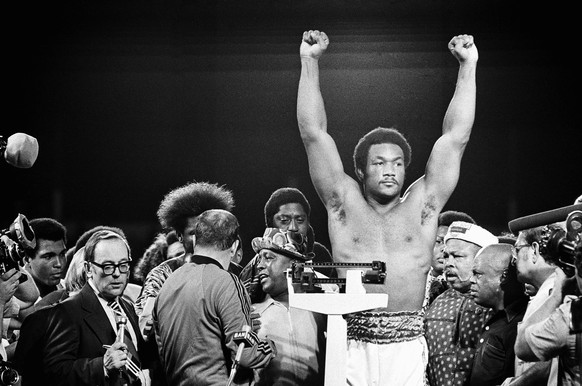 FILE - Heavyweight champion George Foreman responds to cheers of crowd in stadium in Kinshasa, Zaire Saturday night, October 26, 1974 during the weigh in for his title defense against Muhammad Ali. (A ...
