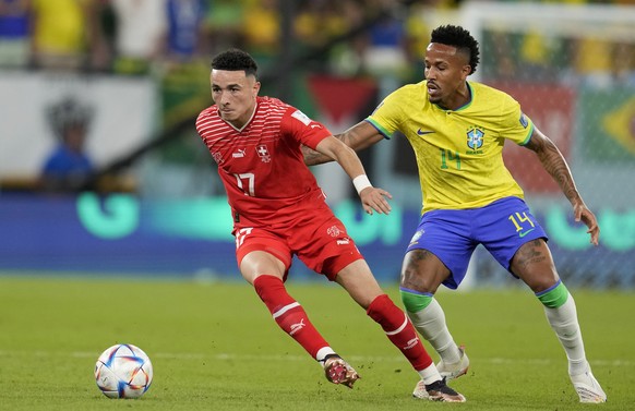 Switzerland's Ruben Vargas, left, and Brazil's Eder Militao challenge for the ball during the World Cup group G soccer match between Brazil and Switzerland, at the Stadium 974 in Doha, Qatar ...