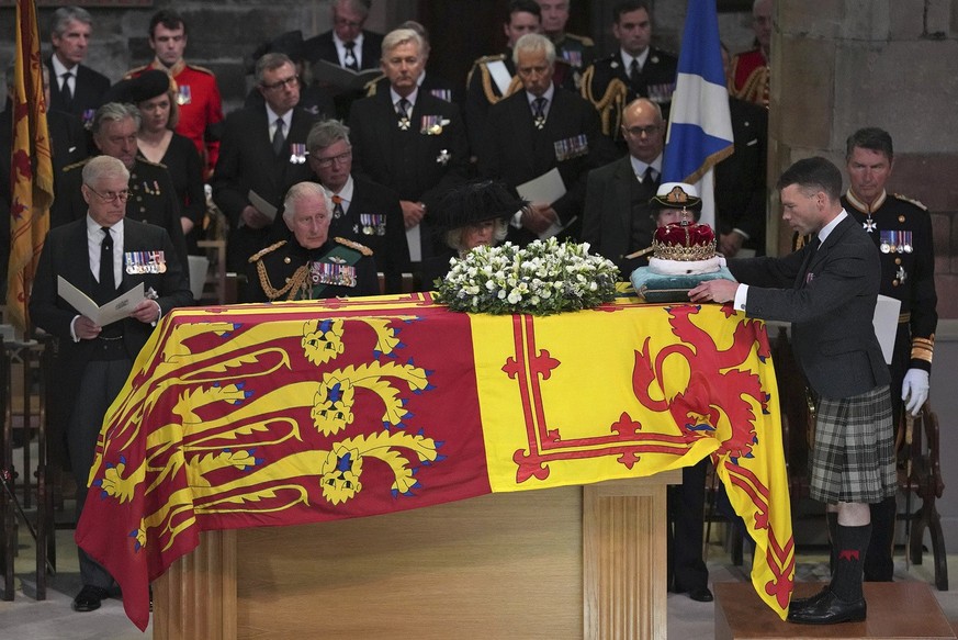 From left, Prince Andrew, King Charles III, Camilla, the Queen Consort, Princess Anne and Vice Admiral Sir Tim Laurence, look on as the Duke of Hamilton places the Crown of Scotland on the coffin duri ...