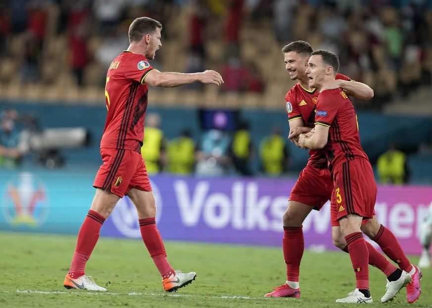 Belgium players celebrate after winning the Euro 2020 soccer championship round of 16 match between Belgium and Portugal at the La Cartuja stadium in Seville, Spain,Sunday, June 27, 2021. (AP Photo/Th ...