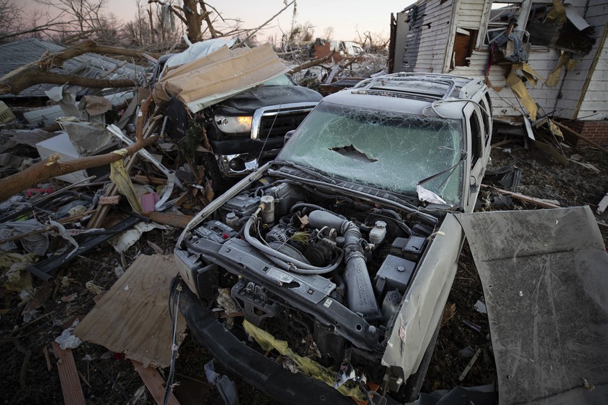 Car sit destroyed among debris after a tornado in Dawson Springs, Ky., Sunday, Dec. 12, 2021. A monstrous tornado, carving a track that could rival the longest on record, ripped across the middle of t ...