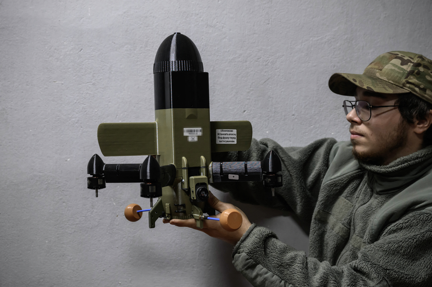 A member of the 3rd Army Corps Interception Squadron holds an interceptor drone used to protect against Russian drone attacks, at an undisclosed location near the front lines of eastern Uraine, on Oct ...