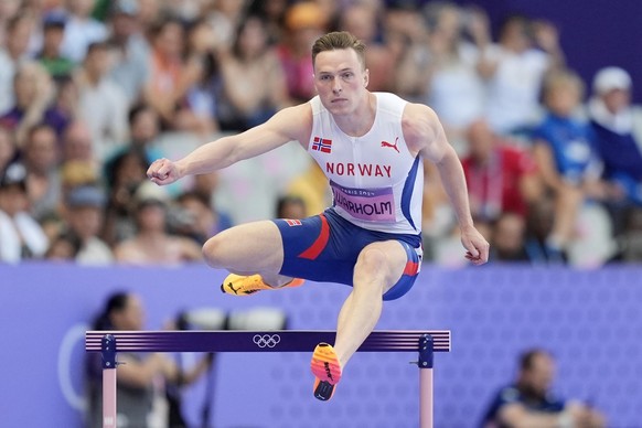 Karsten Warholm, of Norway, competes in a men&#039;s 400 meters hurdles round 1 heat at the 2024 Summer Olympics, Monday, Aug. 5, 2024, in Saint-Denis, France. (AP Photo/Martin Meissner)