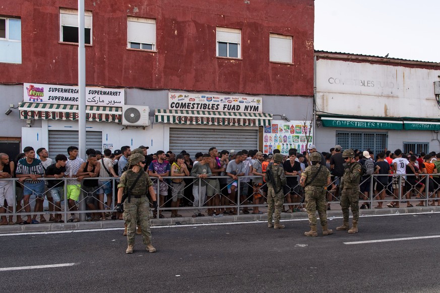 Migrants wait for a shop to open so they can buy food after crossing from Morocco into the Spanish enclave of Ceuta, Friday, July 31, 2026. (AP Photo/Antonio Sempere)
Spain Ceuta