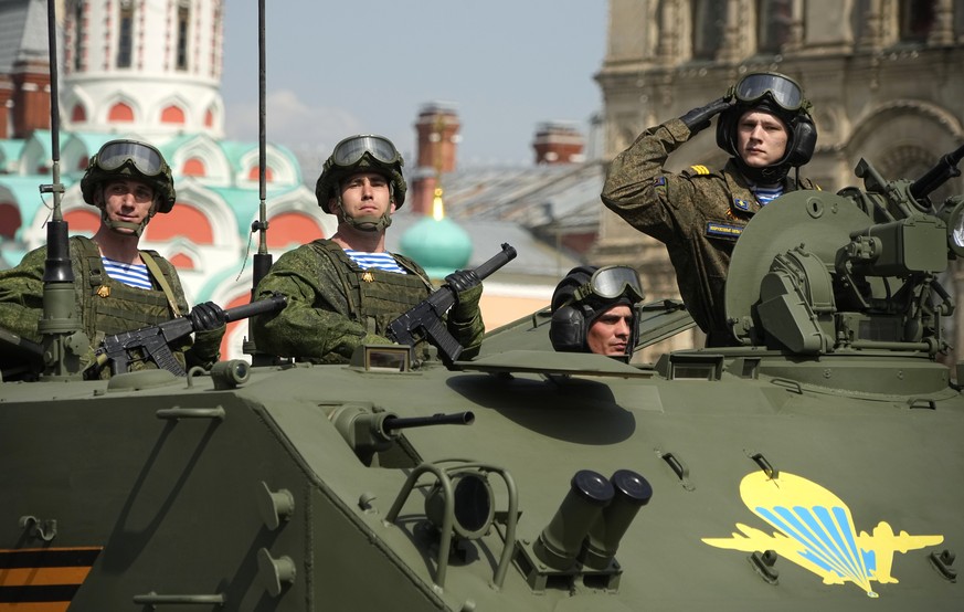 Russian Army soldiers stand in a military vehicle rolling during a dress rehearsal for the Victory Day military parade in Moscow, Russia, Saturday, May 7, 2022. The parade will take place at Moscow&#0 ...