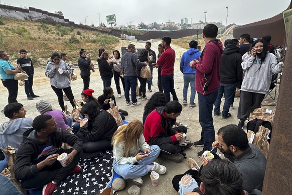 Migrants seeking asylum rest as they wait to be processed after crossing the border Wednesday, June 5, 2024, in San Diego, Calif. President Joe Biden has unveiled plans to enact immediate significant  ...