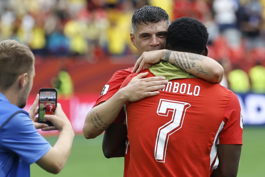 Switzerland's Granit Xhaka, back, celebrates with Switzerland's Breel Embolo, right, after the World Cup round of 16 soccer match between Switzerland and Colombia at the BC Place stadium in  ...