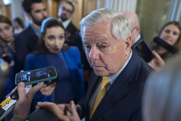 Sen. Lindsey Graham, R-S.C., chairman of the Senate Budget Committee, is surrounded by reporters asking about his plans to move ahead with a spending bill, at the Capitol in Washington, Tuesday, Feb.  ...