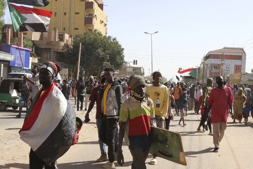 Sudanese demonstrators march in Khartoum, Sudan, Monday, Dec. 26, 2022 to protest a deal signed between the country's main pro-democracy group and its ruling generals, who seized power in an October 2 ...