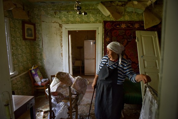 epa09945485 Local resident Tetiana stands inside her damaged house in Zahaltsi village near Kyiv (Kiev), Ukraine, 13 May 2022. On 24 February, Russian troops entered Ukrainian territory starting a con ...