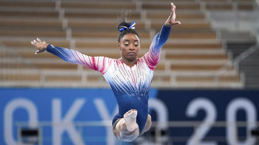 Simone Biles, of the United States, warms up prior to the artistic gymnastics balance beam final at the 2020 Summer Olympics, Tuesday, Aug. 3, 2021, in Tokyo, Japan. (AP Photo/Natacha Pisarenko)