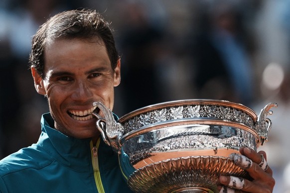 Spain's Rafael Nadal bites the cup after defeating Norway's Casper Ruud in their final match of the French Open tennis tournament at the Roland Garros stadium Sunday, June 5, 2022 in Paris.  ...