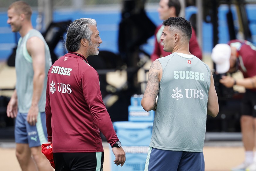 epa13054854 Switzerland's national soccer head coach Murat Yakin talks to his captain Granit Xhaka during a training session of the team at SDJA in San Diego, California, USA, 21 June 2026. Switz ...