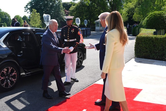 President Donald Trump and first lady Melania Trump greet Britain's King Charles III and Queen Camilla as they arrive at the White House, Monday, April 27, 2026, in Washington (AP Photo/Mark Schi ...