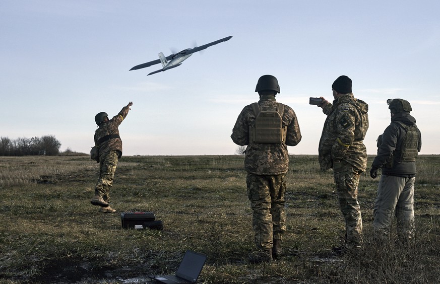 FILE - Ukrainian soldiers launch a drone at Russian positions near Bakhmut, Donetsk region, Ukraine, Thursday, Dec. 15, 2022. (AP Photo/LIBKOS, File)