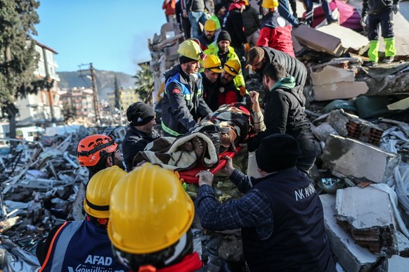 epa10454908 Members of a rescue team carry a survivor, 41-year-old Gokhan Demirtas who was rescued from a collapsed building after 60 hours after an earthquake in Hatay, Turkey, 08 February 2023. More ...