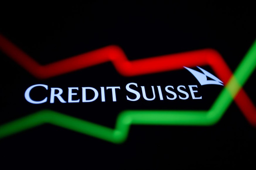An illustrative stock chart and Credit Suisse logo displayed on a phone screen are seen in this multiple exposure illustration photo taken in Krakow, Poland March 20, 2023. (Photo by Jakub Porzycki/Nu ...