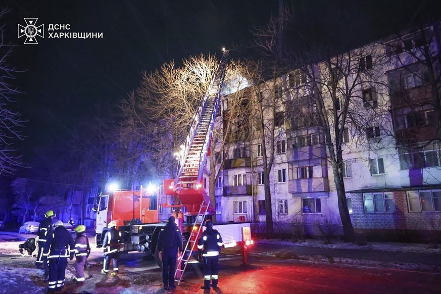 In this photo provided by the Ukrainian Emergency Service, firefighters work on the site of a damaged building after a Russian drone attack in Kharkiv, Ukraine, early Friday, Dec. 13, 2024. (Ukrainian ...