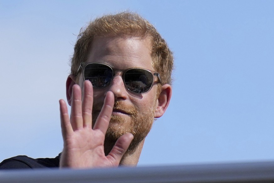FILE - Britain&#039;s Prince Harry, the Duke of Sussex, waves during the Formula One U.S. Grand Prix auto race at Circuit of the Americas, on Oct. 22, 2023, in Austin, Texas. (AP Photo/Nick Didlick, F ...