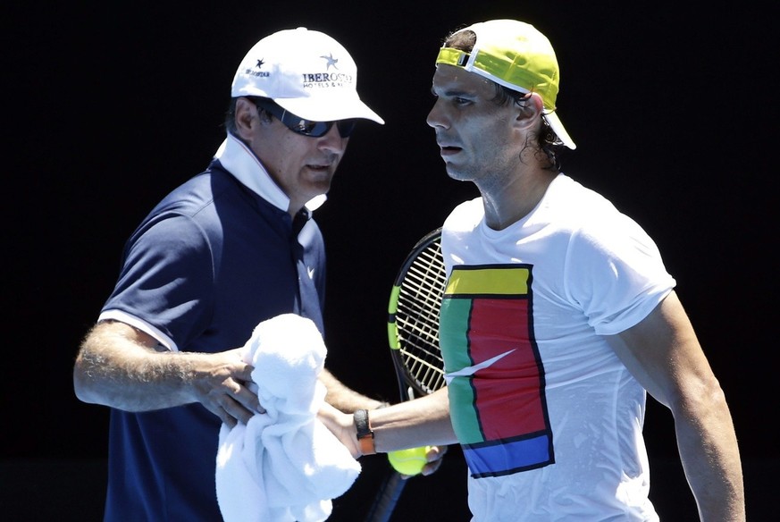 epa05106197 Rafael Nadal of Spain takes a towel from his Coach Toni Nadal during a practice session ahead of the Australian Open tennis tournament at Melbourne Park, in Melbourne, Australia, 17 Januar ...