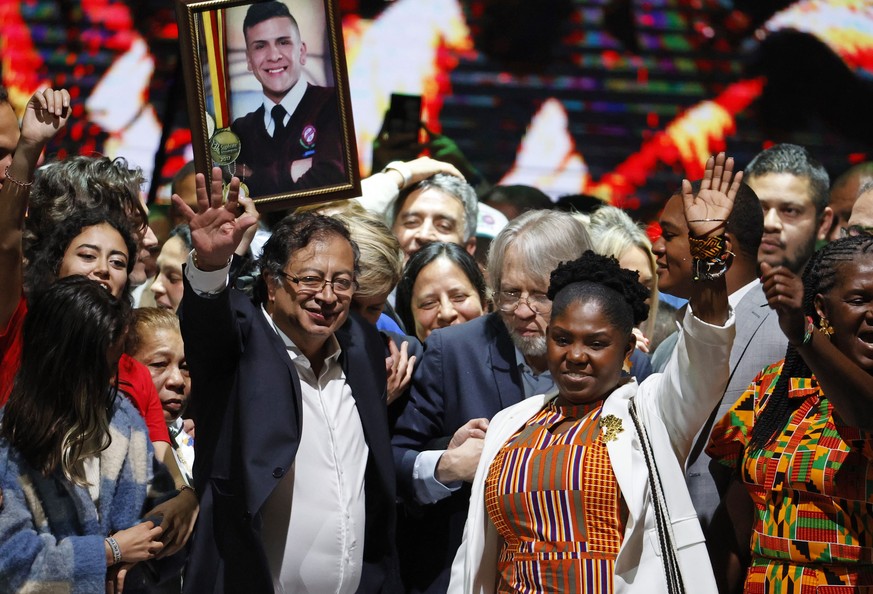 epa10023399 President-elect of Colombia Gustavo Petro (L) celebrates with his vice presidential candidate Francia Marquez (R) during an event at the Movistar Arena in Bogota, Colombia, 19 June 2022. T ...