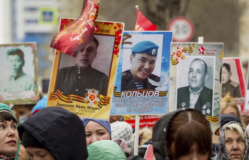 People carry portraits of relatives who fought in World War II, during the Immortal Regiment march in Ulan-Ude, the regional capital of Buryatia, a region near the Russia-Mongolia border, Russia, Mond ...