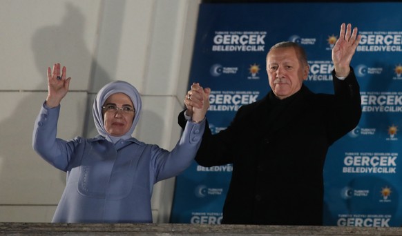 epa11254032 Turkish President Recep Tayyip Erdogan (R) and his wife Emine greet supporters after the polls closed in the local elections in Ankara, Turkey, 31 March 2024. Some 61 million people voted  ...