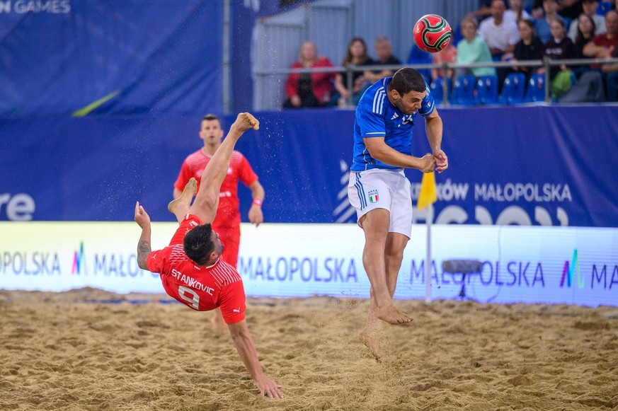 epa10721559 Dejan Stankovic (L) of Switzerland and Luca Bertacca (R) of Italy in action during the Men's Gold Medal Beach Soccer match between Switzerland and Italy at the European Games Krakow 2 ...