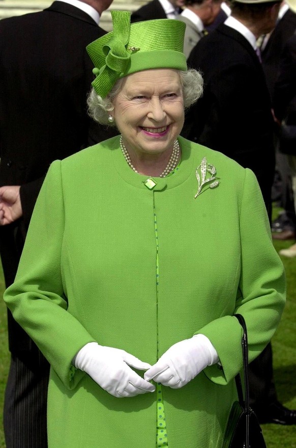 British Queen Elizabeth II dressed in a green outfit, mingles with the crowds in the garden of Buckingham Palace, London Wednesday 11 July 2001, as she attends one of her annual tea parties for 8,000  ...