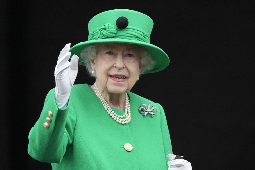 Queen Elizabeth II waves to the crowd during the Platinum Jubilee Pageant at the Buckingham Palace in London, Sunday, June 5, 2022, on the last of four days of celebrations to mark the Platinum Jubile ...