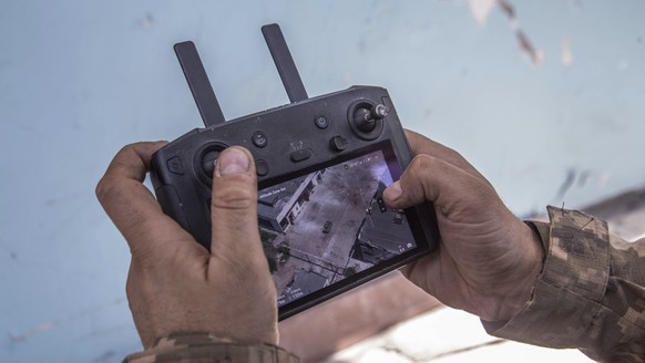 A Ukrainian soldier looks at a drone screen showing Russian troops positions during heavy fighting at the front line in Severodonetsk, Luhansk region, Ukraine, Wednesday, June 8, 2022. (AP Photo/Oleks ...