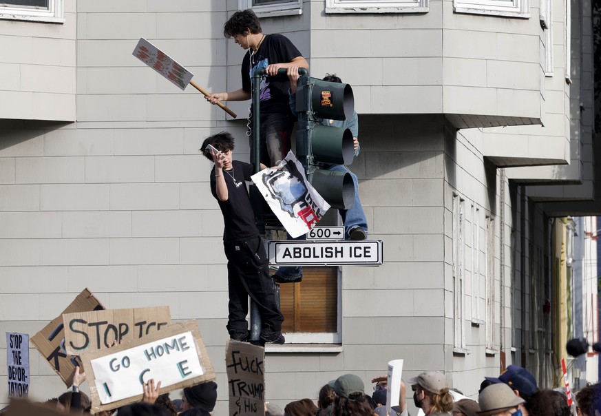 epaselect epa12693680 Anti-ICE protestors climb a street signal light at a rally during a nationwide general strike demonstration at Mission Dolores Park in San Francisco, California, USA, 30 January  ...
