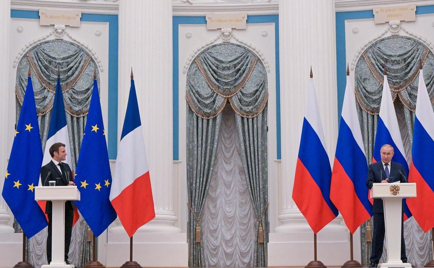 epa09736633 French President Emmanuel Macron (L) and Russian President Vladimir Putin (R) attend a joint press conference following their talks in the Kremlin in Moscow, Russia, early 08 February 2022 ...