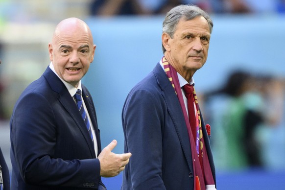 FIFA President Gianni Infantino, left, reacts next to Switzerland&#039;s soccer federation president Dominique Blanc, right, during the FIFA World Cup Qatar 2022 group G soccer match between Switzerla ...