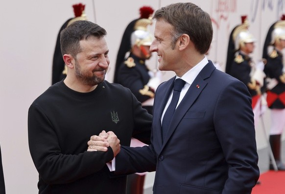Ukrainian President Volodymyr Zelenskyy and his wife Olena Zelenska, arrive with French President Emmanuel Macron, right, and his wife Brigitte Macron, left, at the international ceremony at Omaha Bea ...
