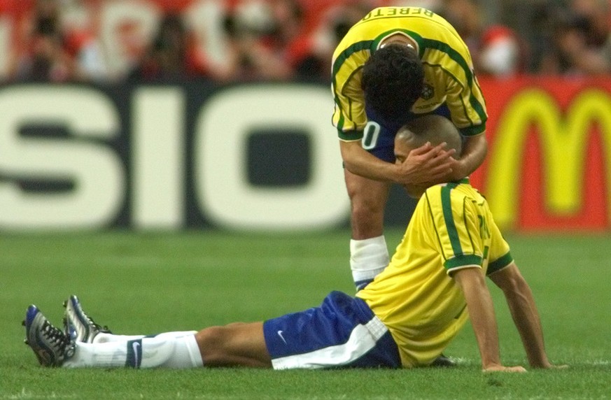 Brazil&amp;#039;s Ronaldo, on ground, is consoled by teammate Bebeto after France defeated Brazil 3-0 during the final of the soccer World Cup 98 between Brazil and France at the Stade de France in Sa ...