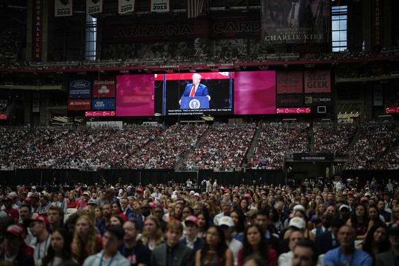 President Donald Trump, seen on a stadium screen, speaks at a memorial for conservative activist Charlie Kirk, Sunday, Sept. 21, 2025, at State Farm Stadium in Glendale, Ariz. (AP Photo/John Locher)
C ...